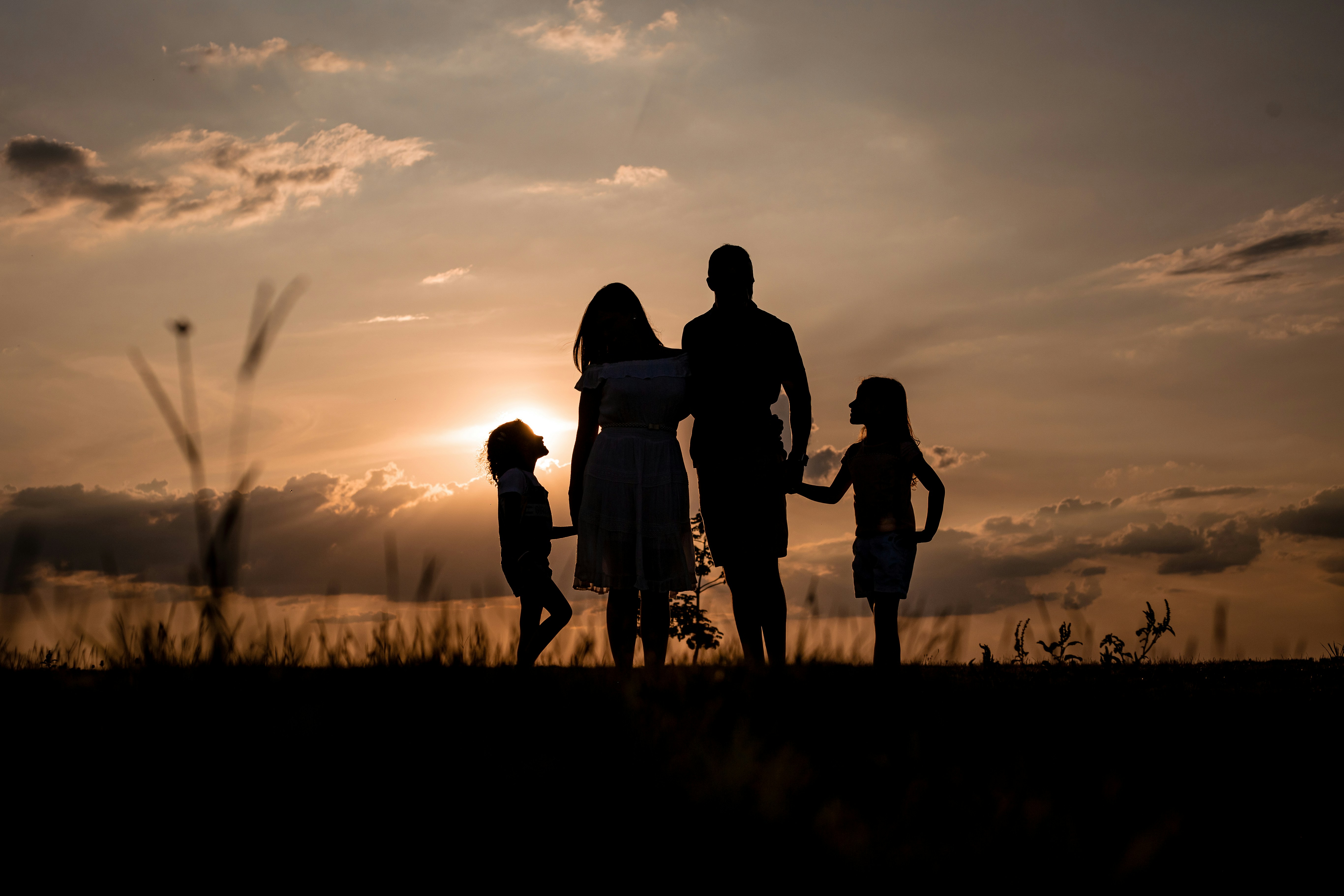 Family silhouette at sunset - Representing all family members welcome at Waukegan Immediate Care